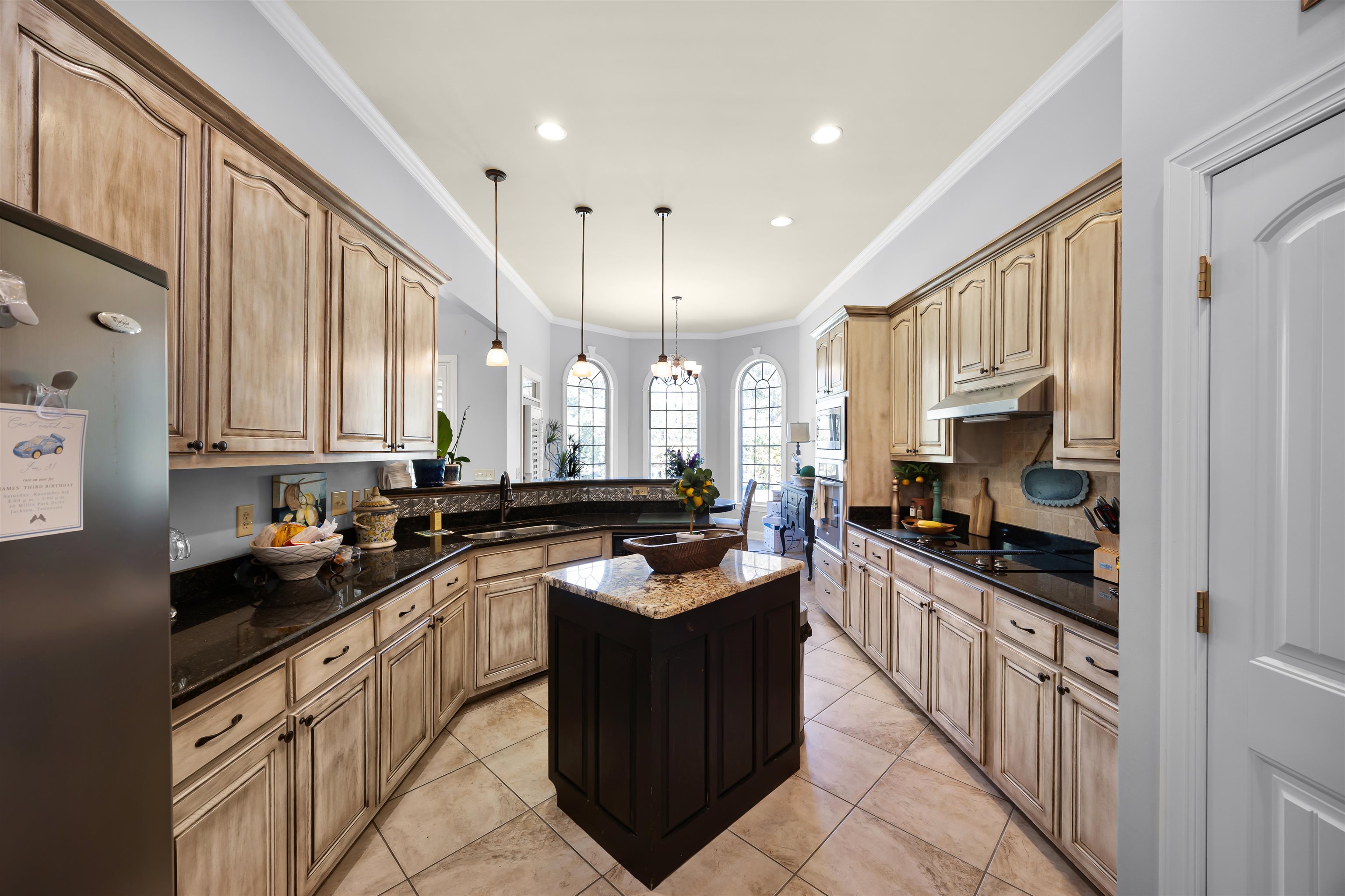140 Legends Drive Counce, TN 38326 - Photo 12 of 30 Kitchen with crown molding, dark stone counters, pendant lighting, appliances with stainless steel finishes, and a center island