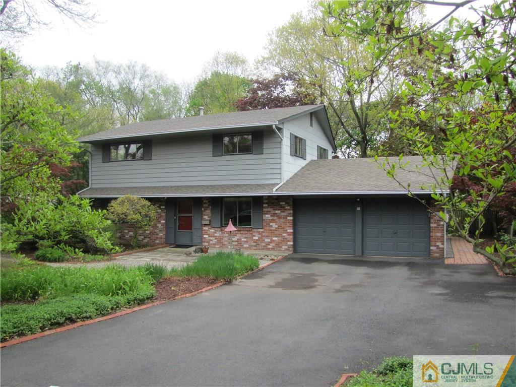 32 Raleigh Road Kendall Park, NJ 08824 - Photo 1 of 18 a front view of a house with a garden