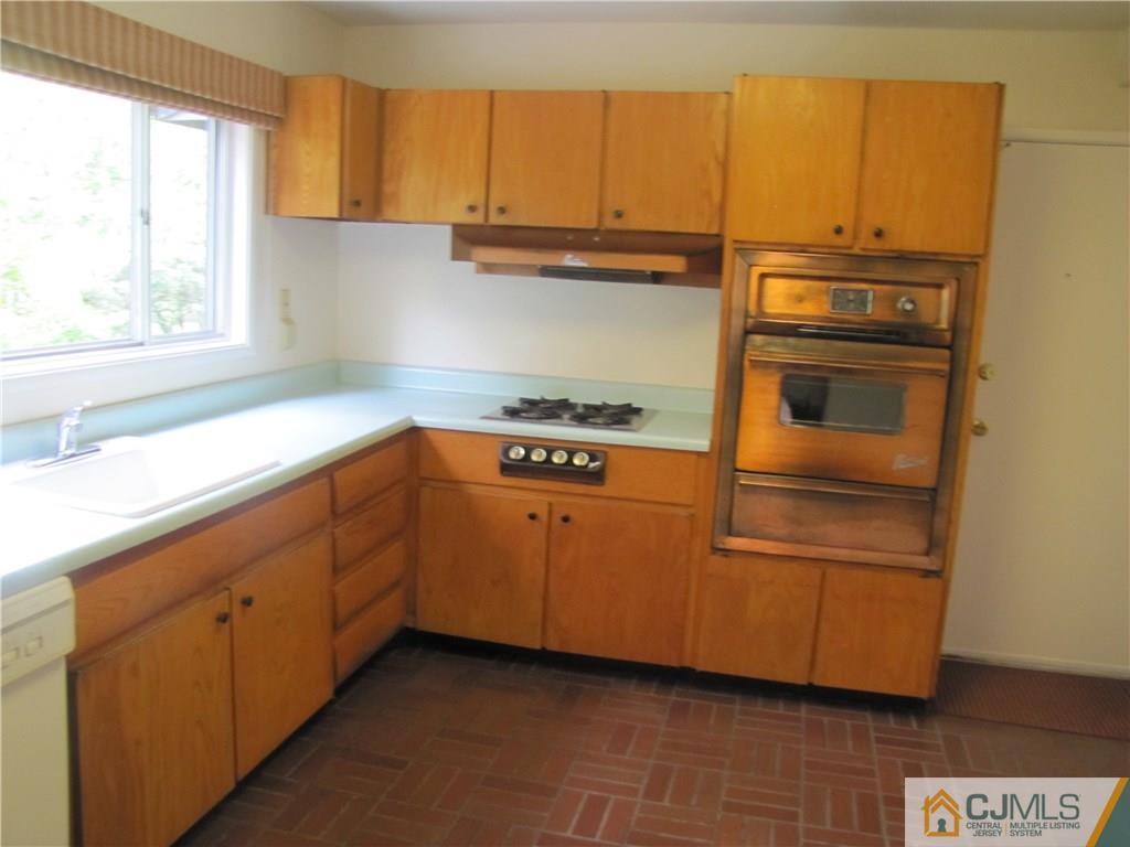 32 Raleigh Road Kendall Park, NJ 08824 - Photo 11 of 18 a kitchen with a sink and a window