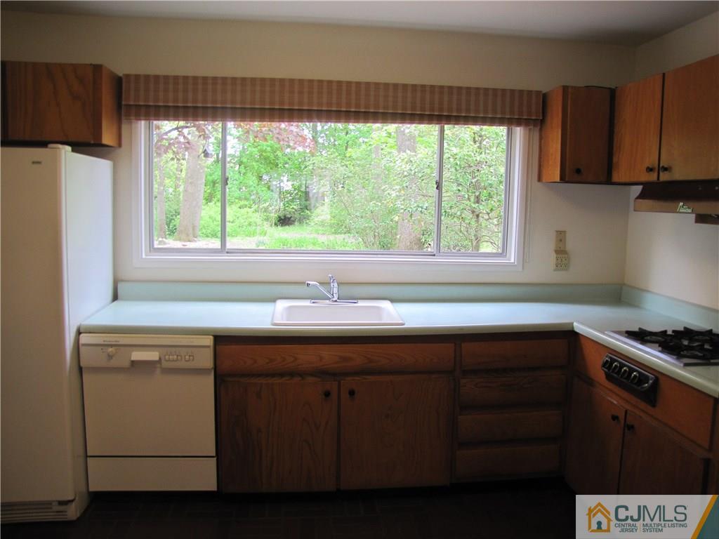 32 Raleigh Road Kendall Park, NJ 08824 - Photo 12 of 18 a kitchen with a sink window and cabinets