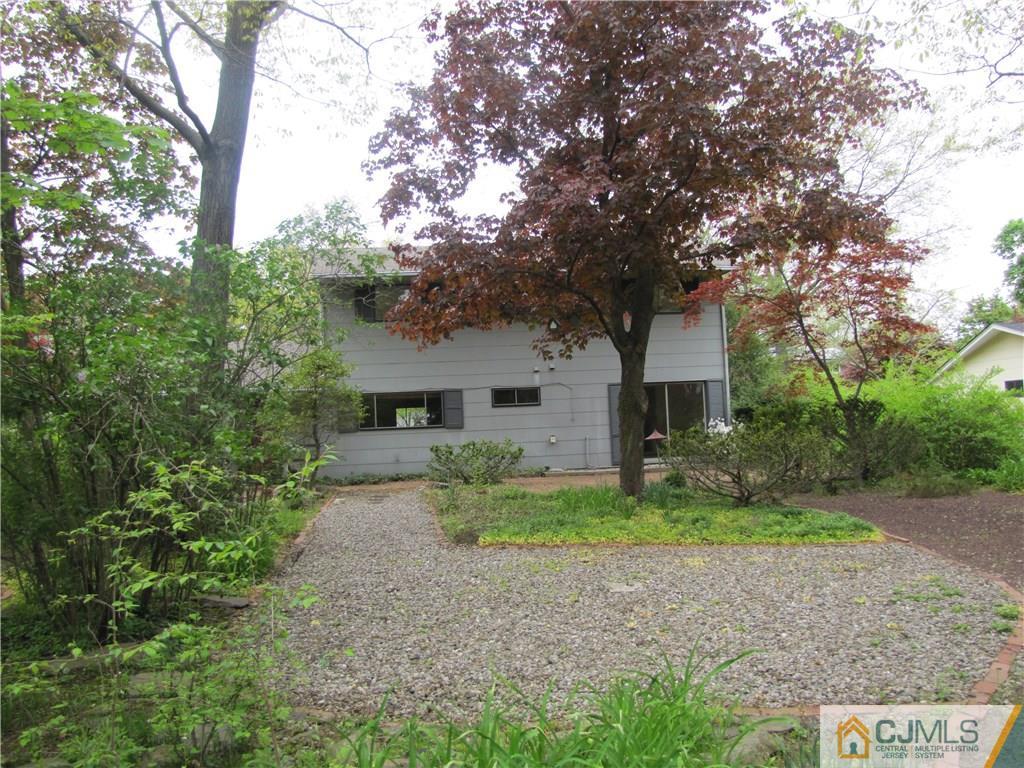 32 Raleigh Road Kendall Park, NJ 08824 - Photo 17 of 18 a front view of a house with a yard and garage