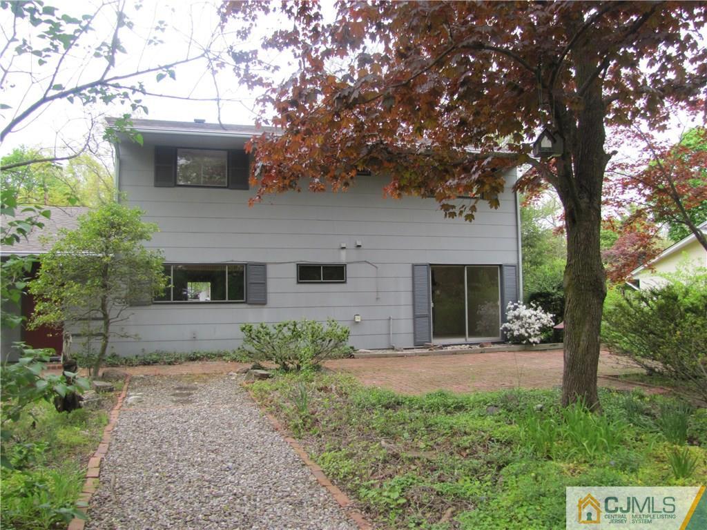 32 Raleigh Road Kendall Park, NJ 08824 - Photo 18 of 18 a front view of a house with a yard and potted plants