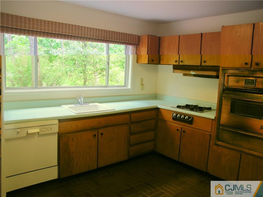 32 Raleigh Road Kendall Park, NJ 08824 - Photo 10 of 18 a kitchen with a sink cabinets and a large window