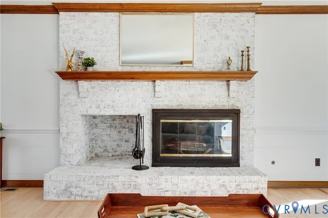 a living room with furniture large window and a fireplace
