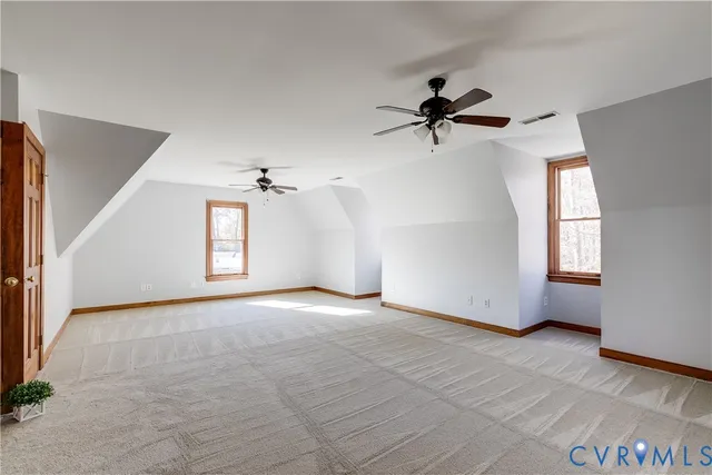 a view of a livingroom with furniture and a ceiling fan
