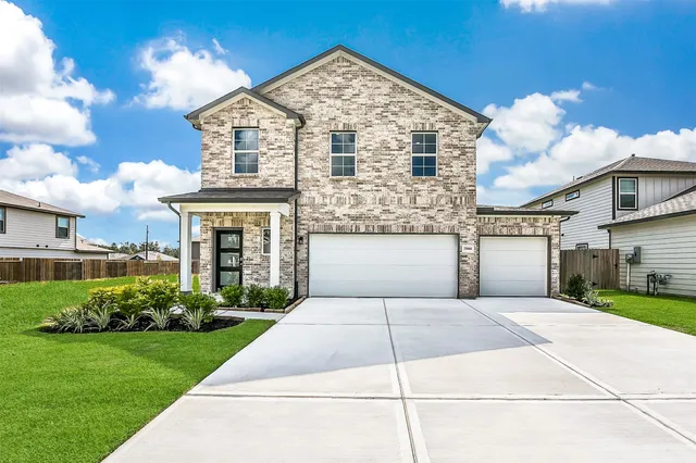 a front view of a house with a garden and plants