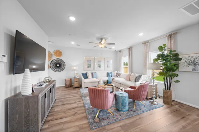 a living room with furniture a wooden floor and chandelier