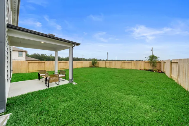 a view of yard with swimming pool and green space