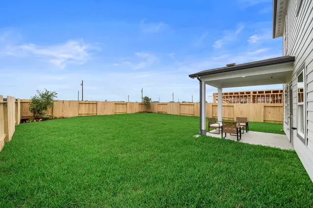 a view of a backyard with sitting area