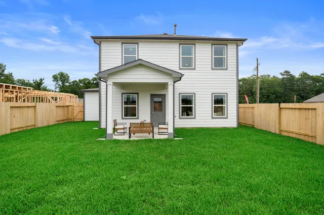 a view of a house with a yard and sitting area