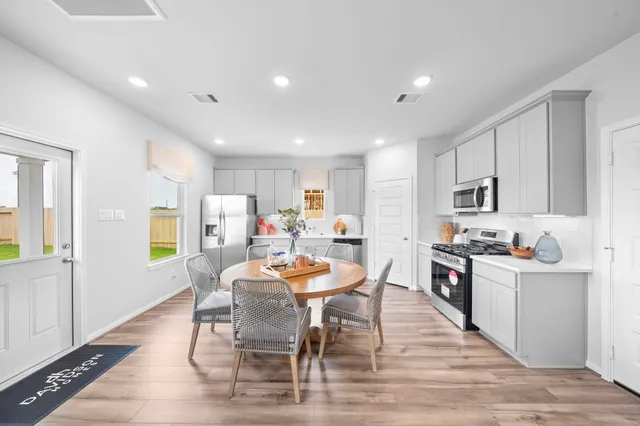 a view of a dining room with furniture and wooden floor