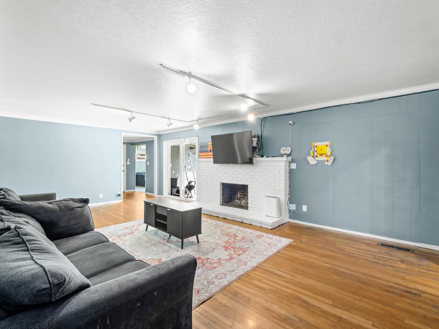 519 West Rialto Avenue Fresno, CA 93705 - Photo 14 of 36 a living room with furniture and a fireplace