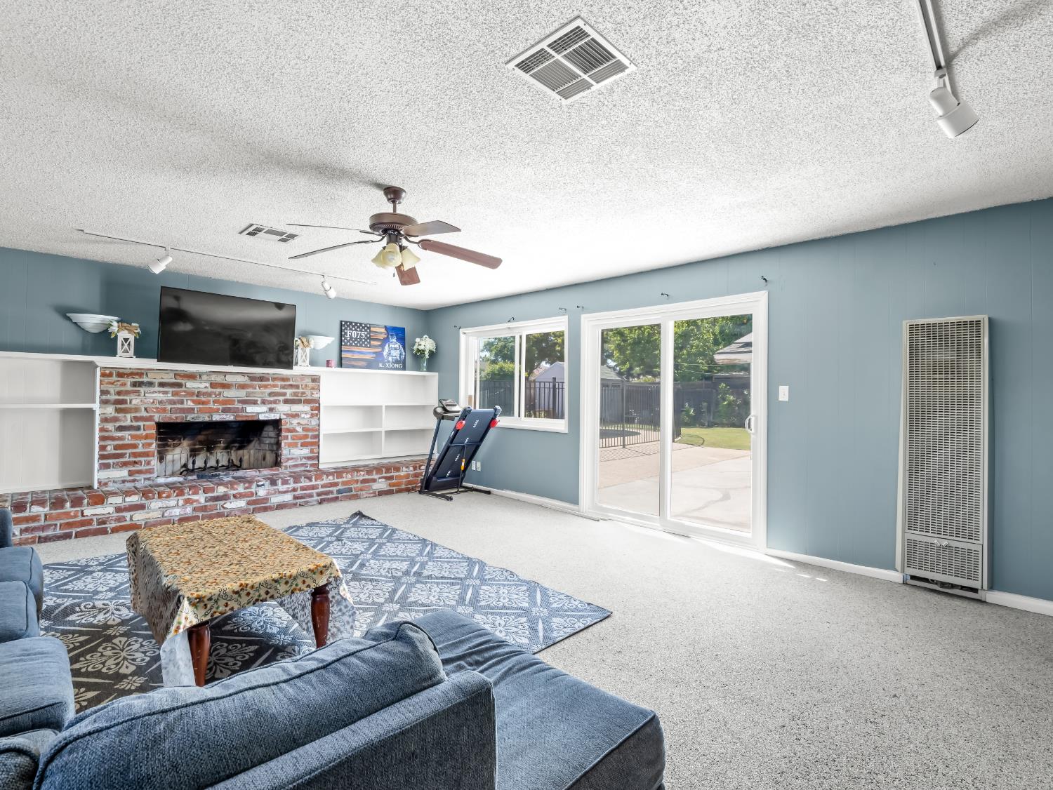 519 West Rialto Avenue Fresno, CA 93705 - Photo 15 of 36 a living room with furniture and a fireplace