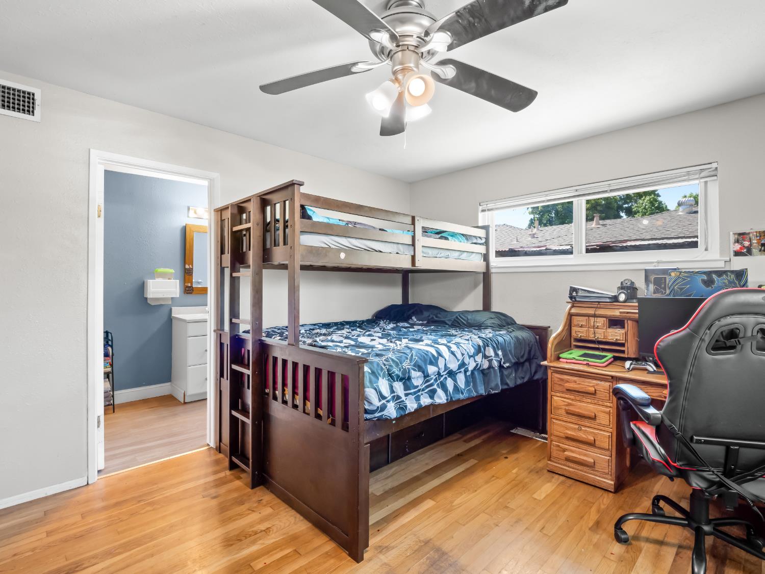 519 West Rialto Avenue Fresno, CA 93705 - Photo 20 of 36 a bedroom with a bed and a chandelier