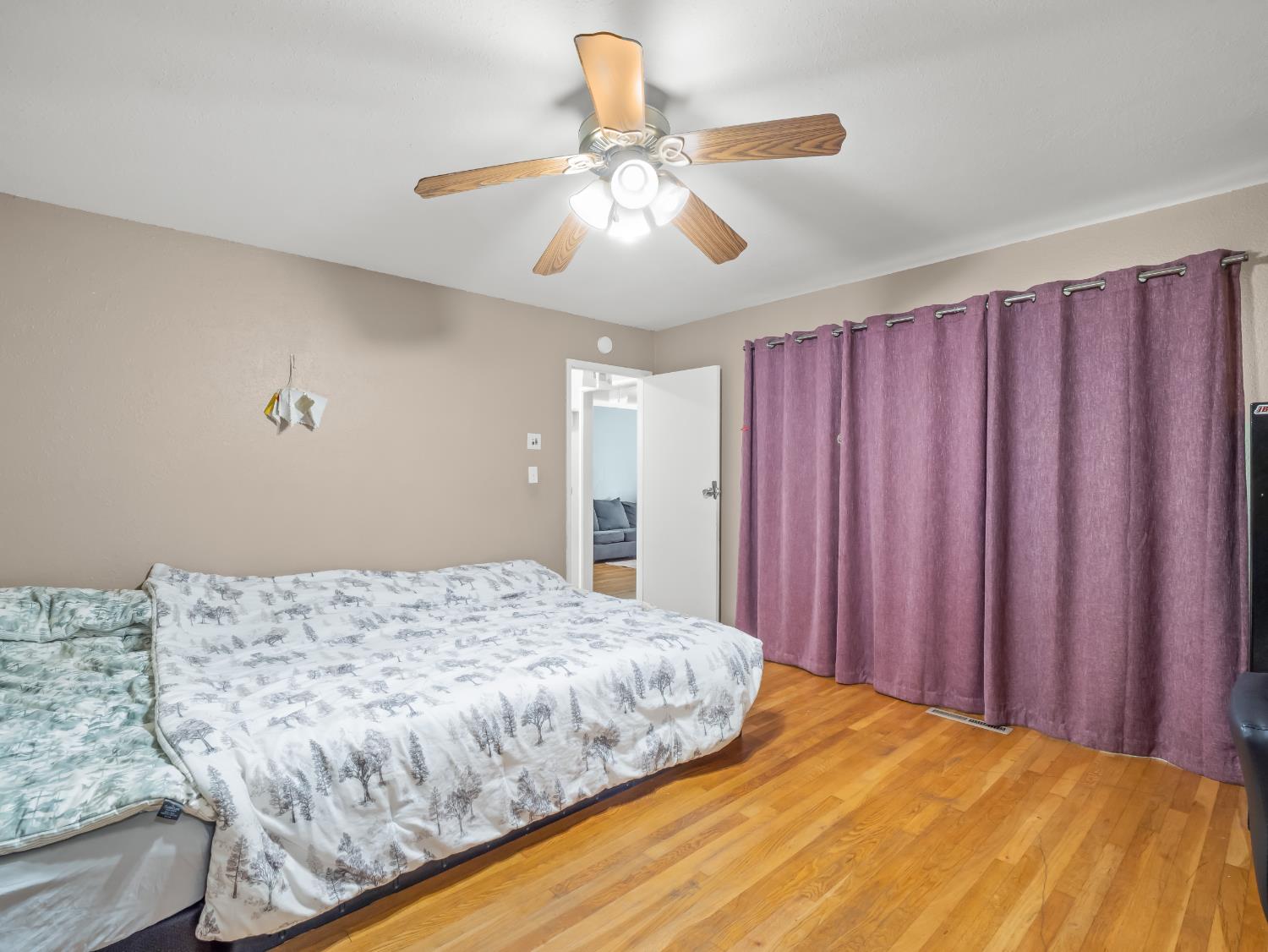 519 West Rialto Avenue Fresno, CA 93705 - Photo 24 of 36 a bedroom with a large bed and a chandelier