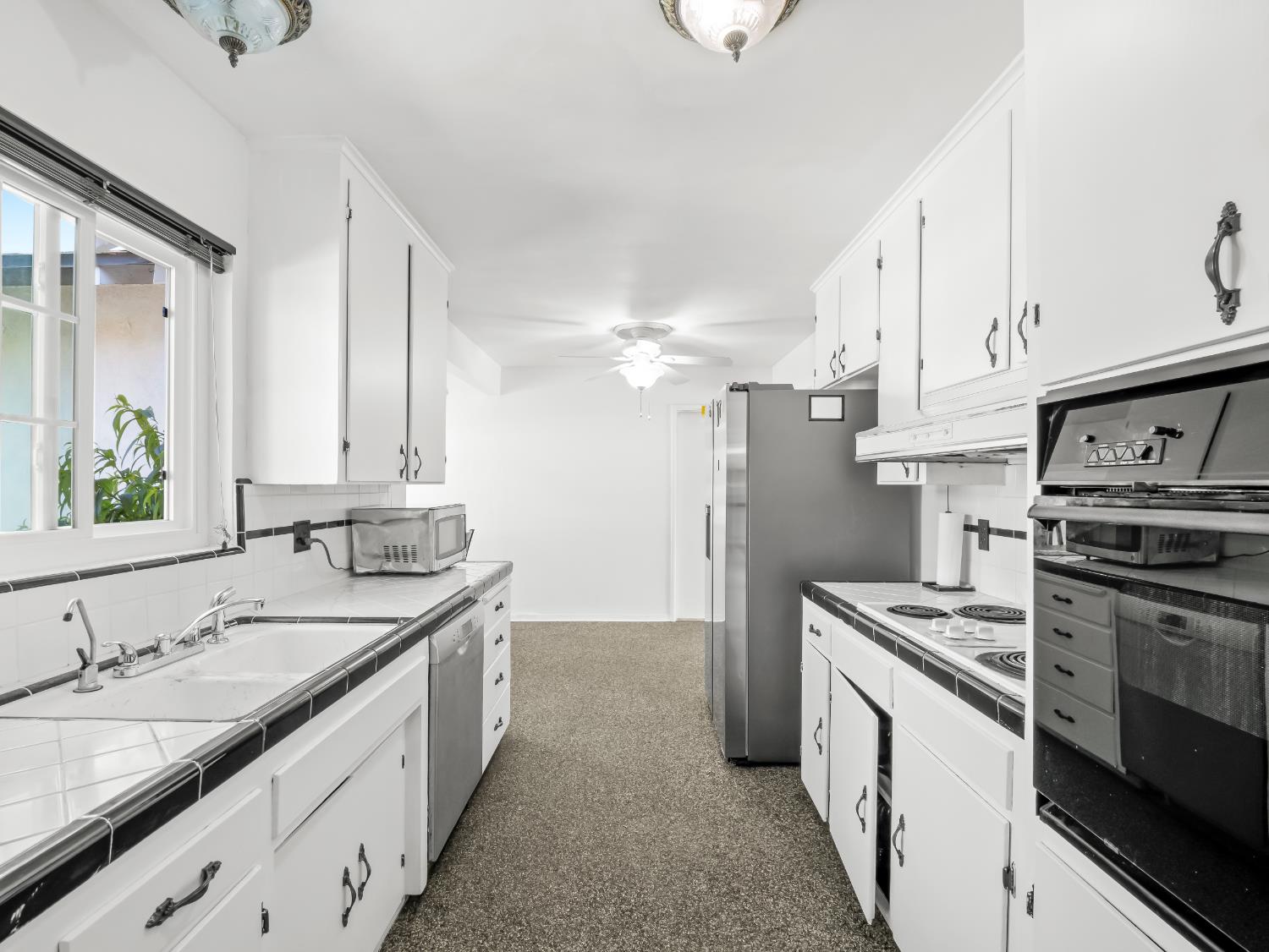 519 West Rialto Avenue Fresno, CA 93705 - Photo 4 of 36 a kitchen with stainless steel appliances granite countertop a sink stove and refrigerator