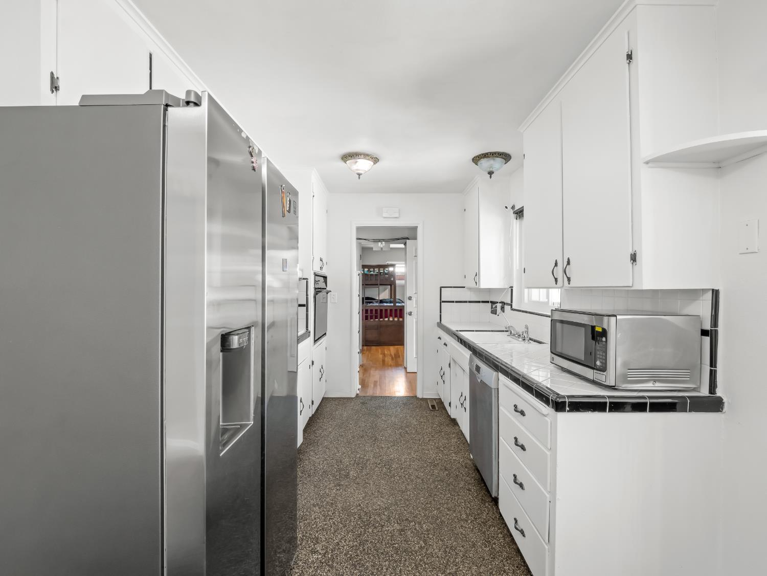 519 West Rialto Avenue Fresno, CA 93705 - Photo 6 of 36 a kitchen with stainless steel appliances granite countertop a refrigerator a stove and a sink
