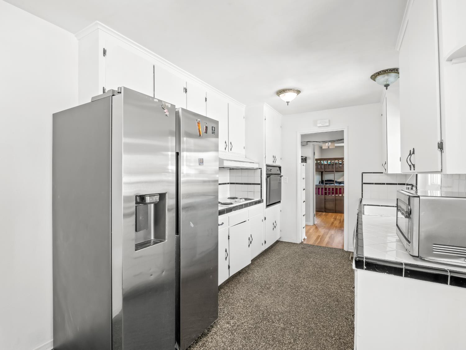 519 West Rialto Avenue Fresno, CA 93705 - Photo 7 of 36 a kitchen with kitchen island a counter top space a sink appliances and cabinets