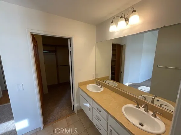 a spacious bathroom with a double vanity sink and a mirror