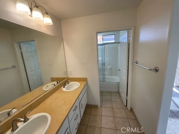a bathroom with a granite countertop sink a toilet and mirror