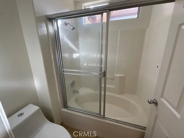 a bathroom with a glass shower door