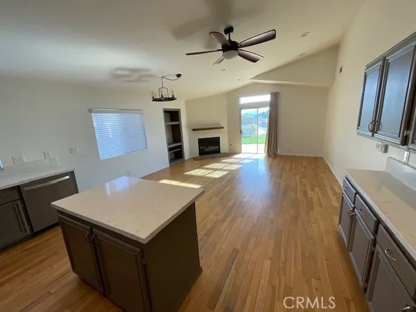 a view of a kitchen cabinets wooden floor and a ceiling fan