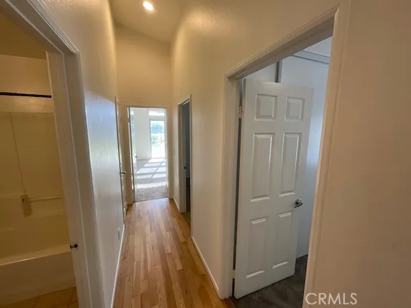 a view of a hallway with wooden floor