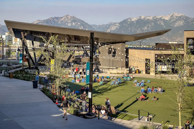 11014 South Lake Run Road, Unit 146 South Jordan, UT 84009 - Photo 22 of 22 Expansive outdoor amphitheater featuring a broad concrete stage with overhead structure, a manicured green lawn, and string lighting