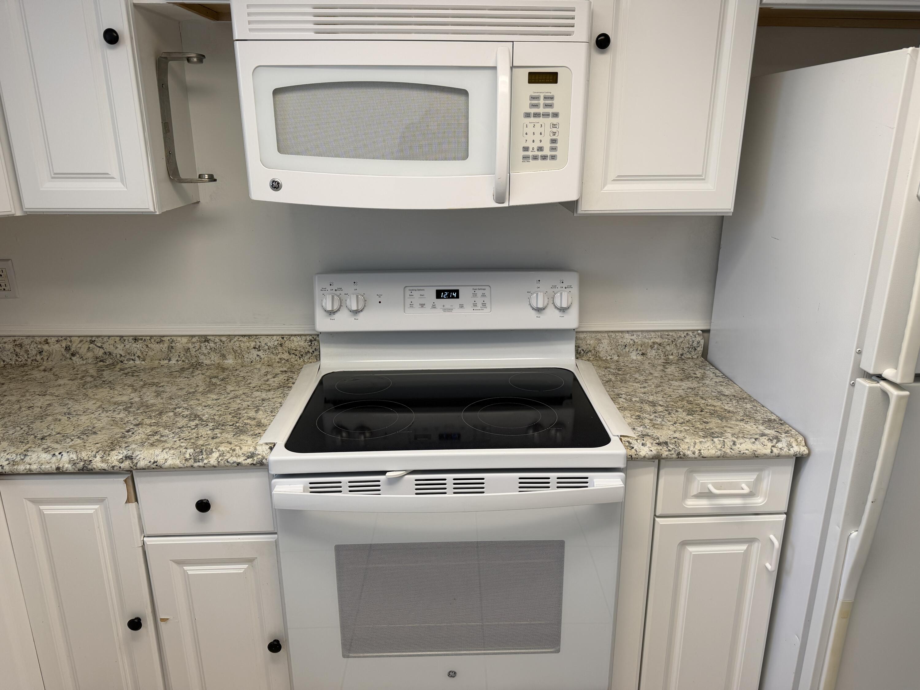 506 Davis Road, Unit 70 Palm Springs, FL 33461 - Photo 16 of 25 a stove top oven sitting inside of a kitchen