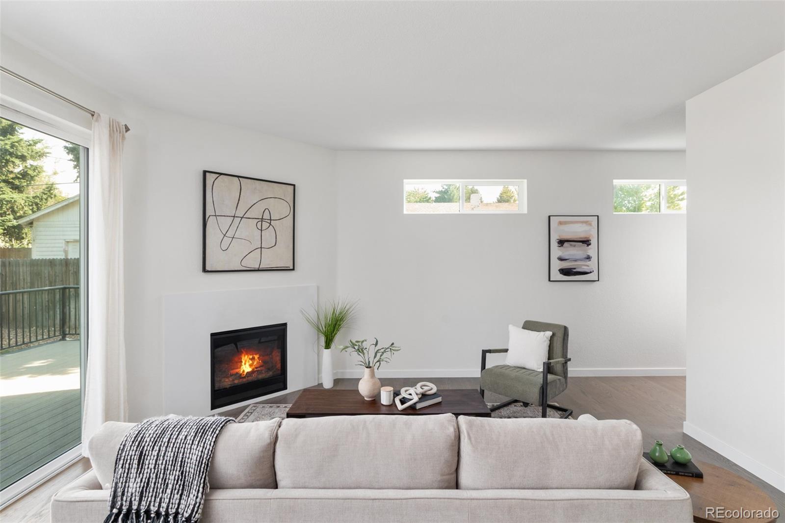 5230 Stuart Street Denver, CO 80212 - Photo 5 of 34 a living room with furniture and a fireplace
