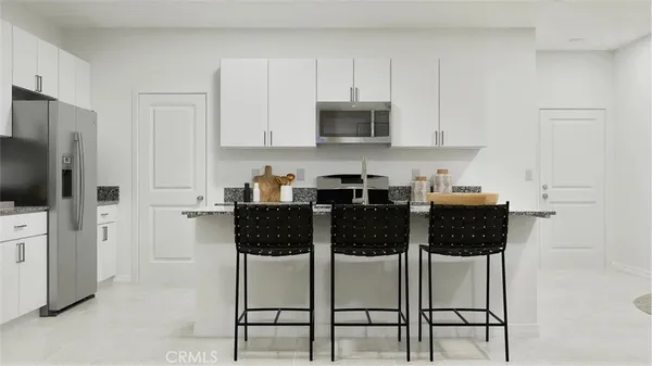 a kitchen with stainless steel appliances a stove a sink a microwave and cabinets