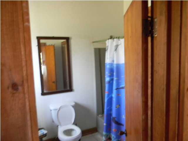 8346 Creston Barrow Road Baker, FL 32531 - Photo 9 of 13 a bathroom with a toilet and a mirror