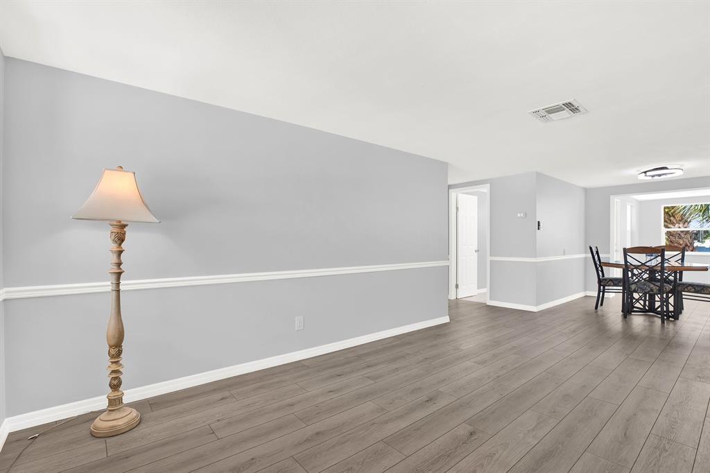 13739 Lavender Avenue Hudson, FL 34667 - Photo 12 of 25 a view of a room with wooden floor table and chairs