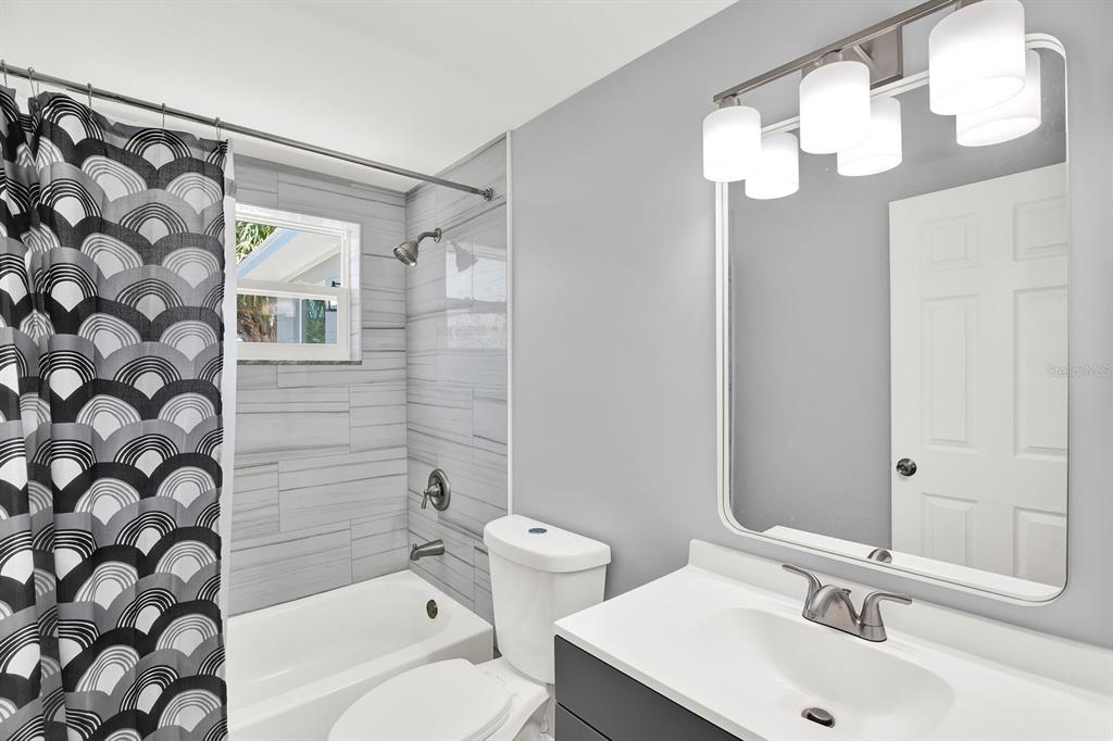 13739 Lavender Avenue Hudson, FL 34667 - Photo 14 of 25 a bathroom with a sink a toilet and shower