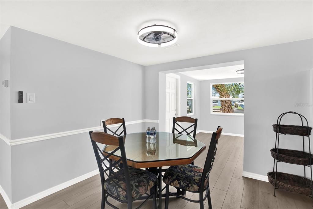 13739 Lavender Avenue Hudson, FL 34667 - Photo 5 of 25 a view of a dining room with furniture and wooden floor