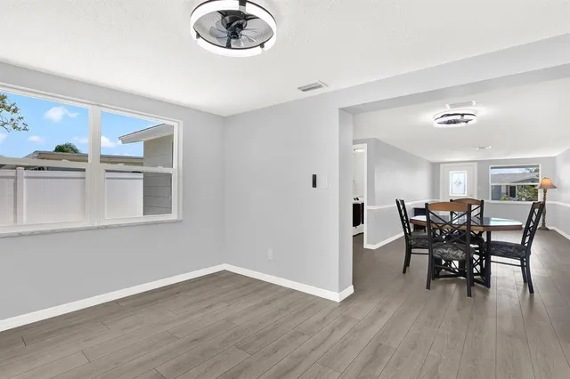a view of a dining room with furniture and wooden floor
