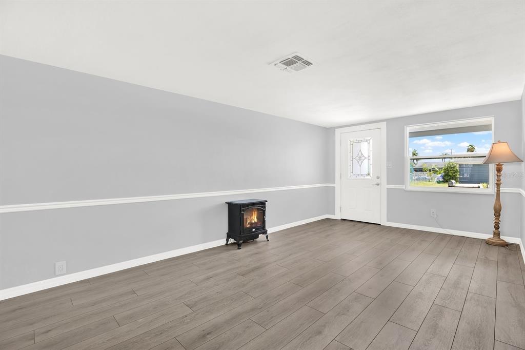 13739 Lavender Avenue Hudson, FL 34667 - Photo 8 of 25 wooden floor in an empty room with a window