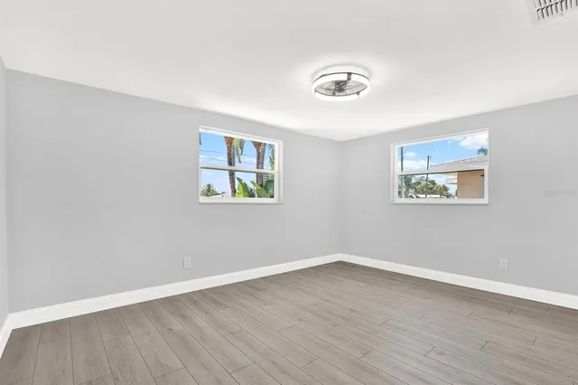 a view of a room with wooden floor and window
