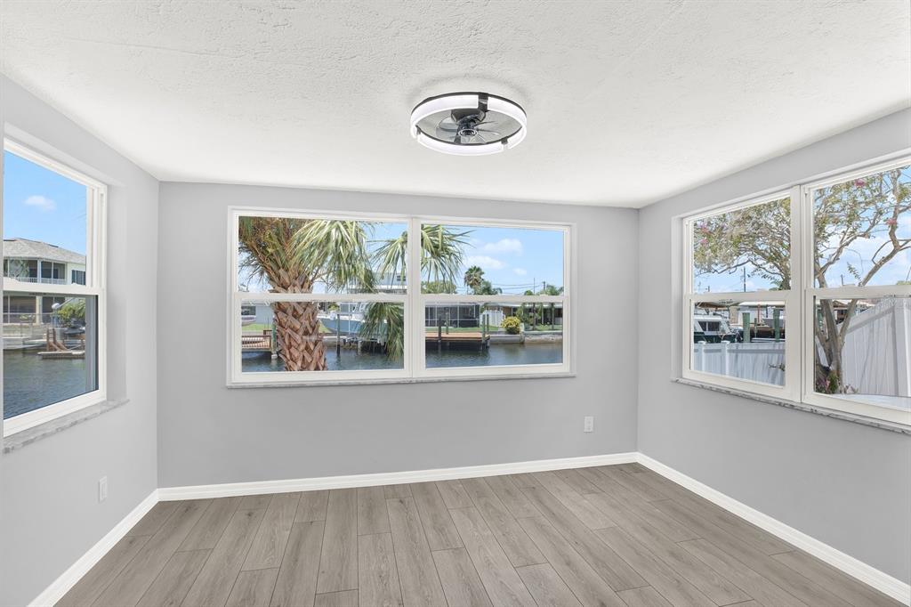 13739 Lavender Avenue Hudson, FL 34667 - Photo 10 of 25 an empty room with wooden floor and windows