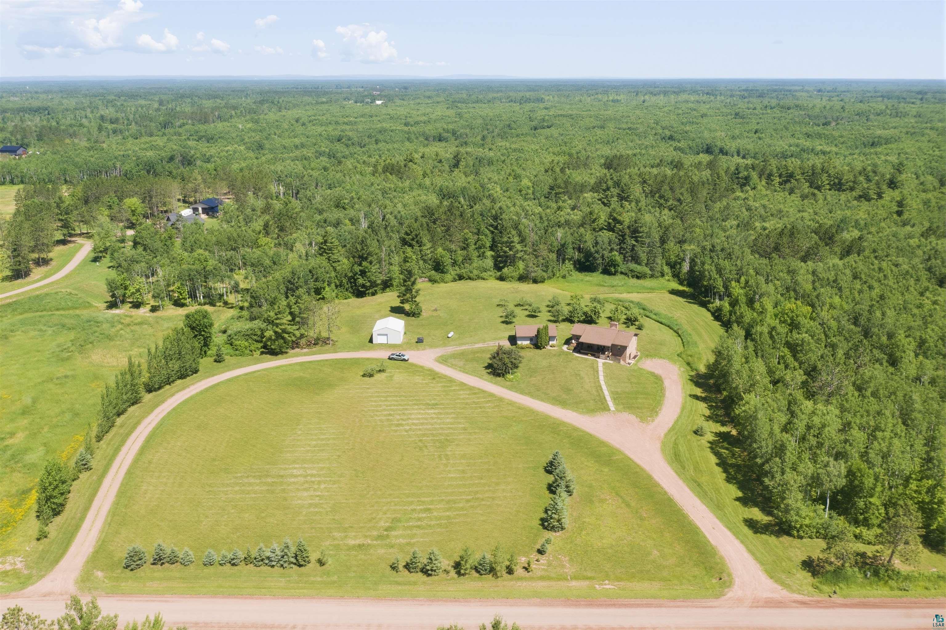 64260 Jolma Road Ashland, WI 54806 - Photo 34 of 35 Expansive land featuring a main residence, an additional smaller structure, and a large white outbuilding