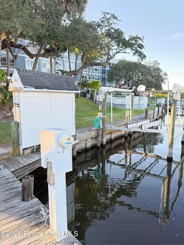 a view of a patio with table and chairs with wooden floor and fence