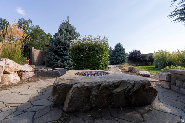 687 South 2080th Street East Springville, UT 84663 - Photo 104 of 149 Outdoor fire pit crafted from natural stone, surrounded by flagstone paving