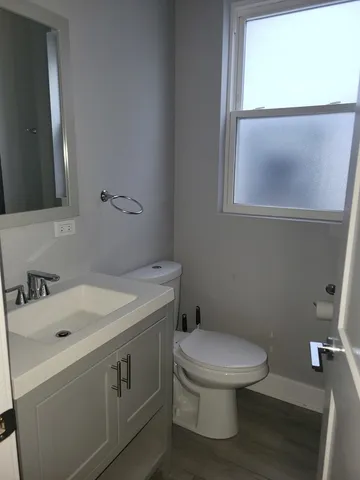 a bathroom with a sink a toilet and a mirror
