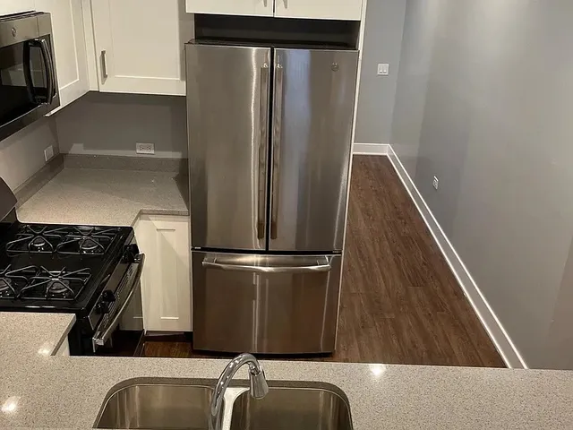 a stove top oven sitting inside of a kitchen
