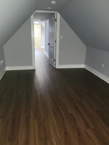 a view of a room with wooden floor and staircase