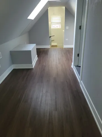 a view of a room with wooden floor and stairs