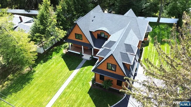 an aerial view of a house with swimming pool and garden