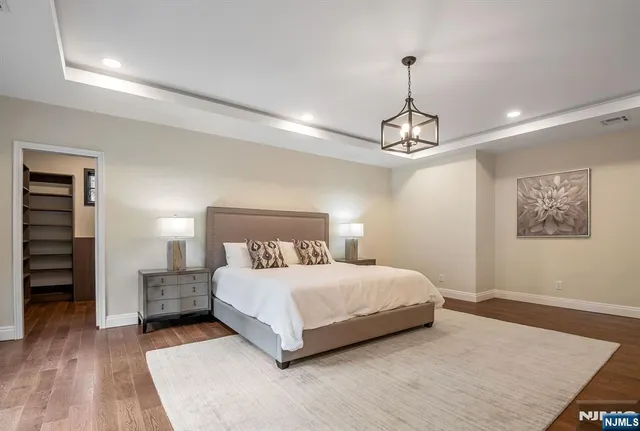 a bedroom with a bed and a chandelier