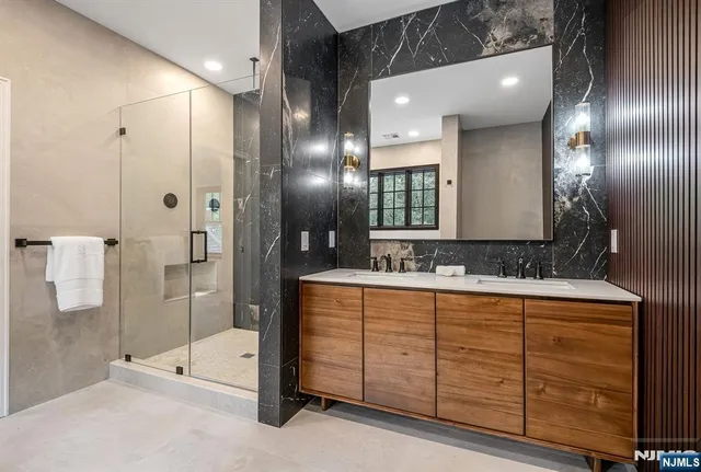 a bathroom with a double vanity sink and a mirror