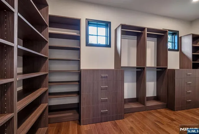 a view of walk in closet with empty racks